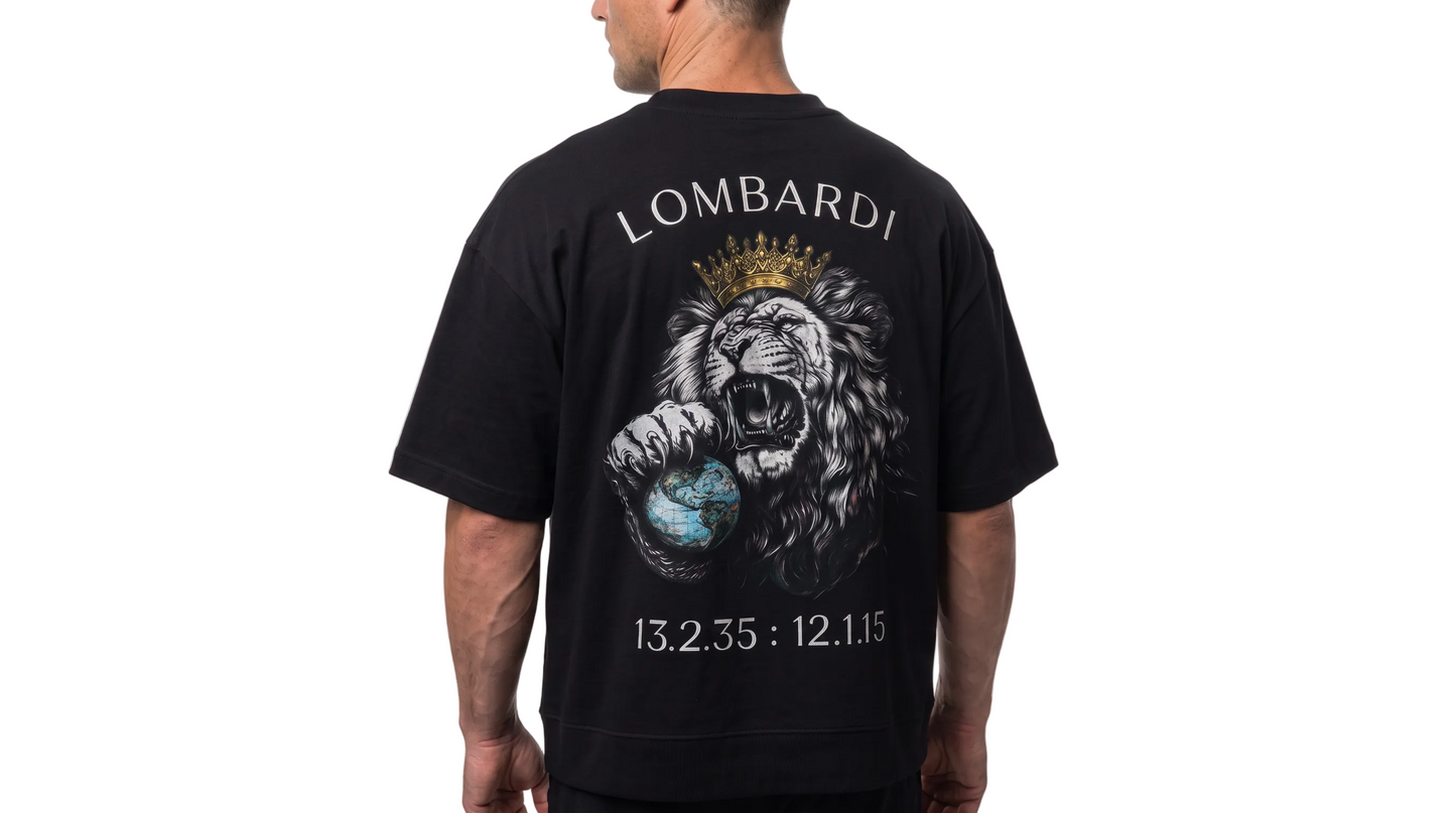 A man viewed from the back wearing a black short-sleeve t-shirt with a large graphic print of a lion wearing a gold crown and holding a blue globe, with the brand name 'LOMBARDI' printed above.